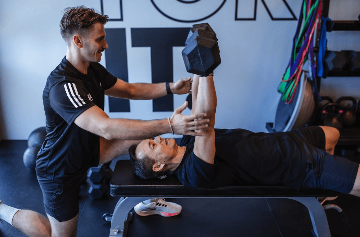 UBX coach assisting an athlete with boxing technique during a personalized training session at UBX Training Ealing.