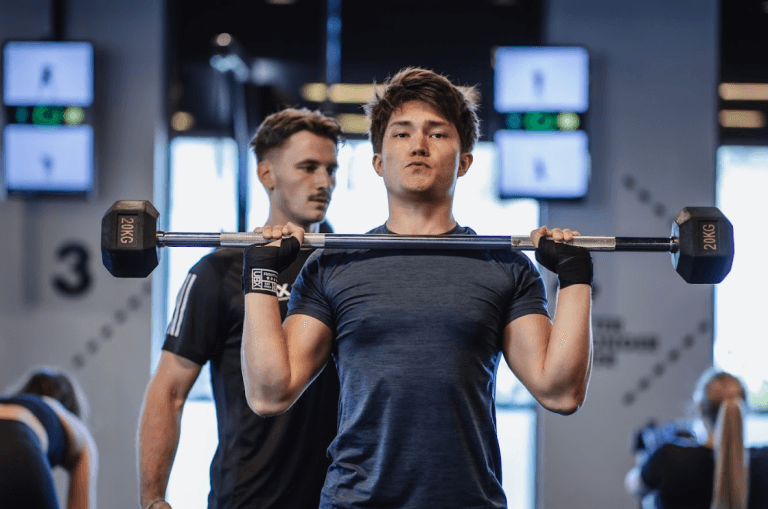 Man lifting dumbbells during a strength workout in the gym